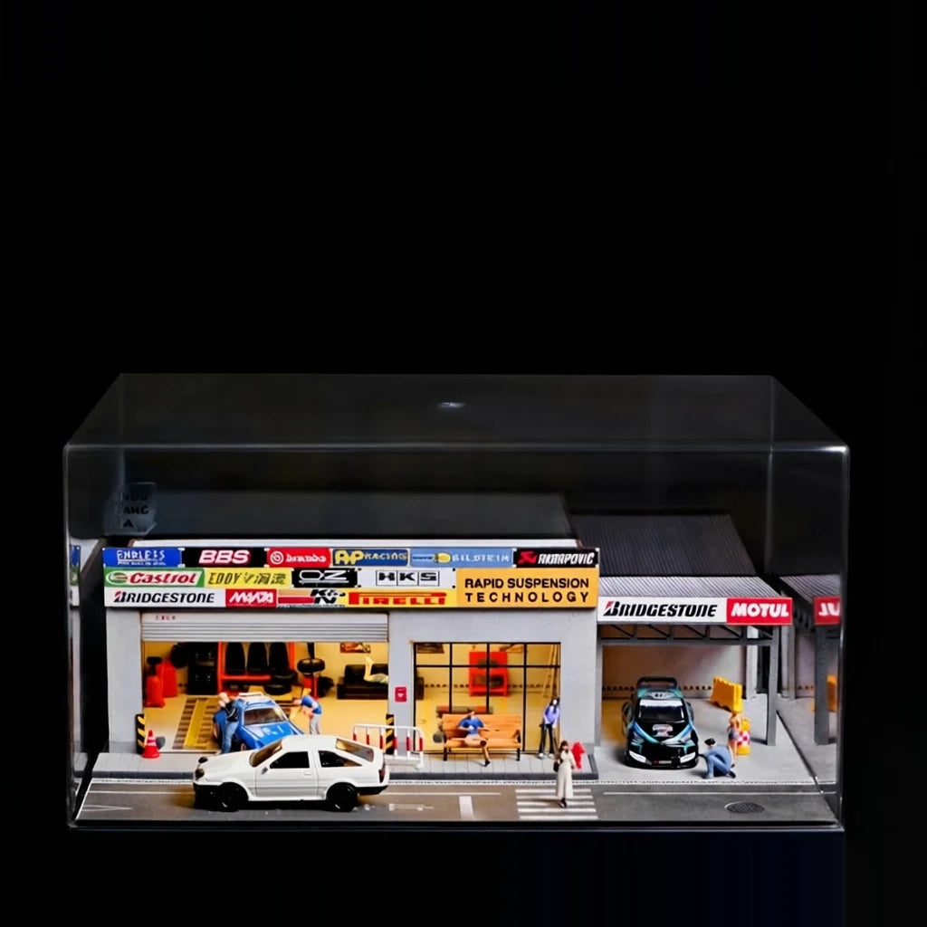 1:64 Japanese repair shop diorama lit up inside a clear display case on a black studio background