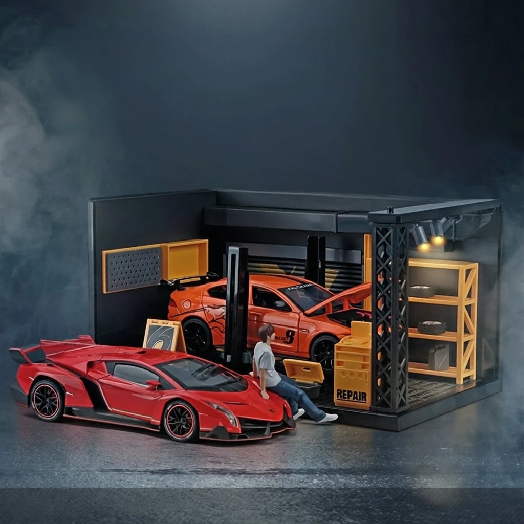 The 1:24 garage display case lit from inside with a model car on the lift, a red supercar and a mechanic figure in front