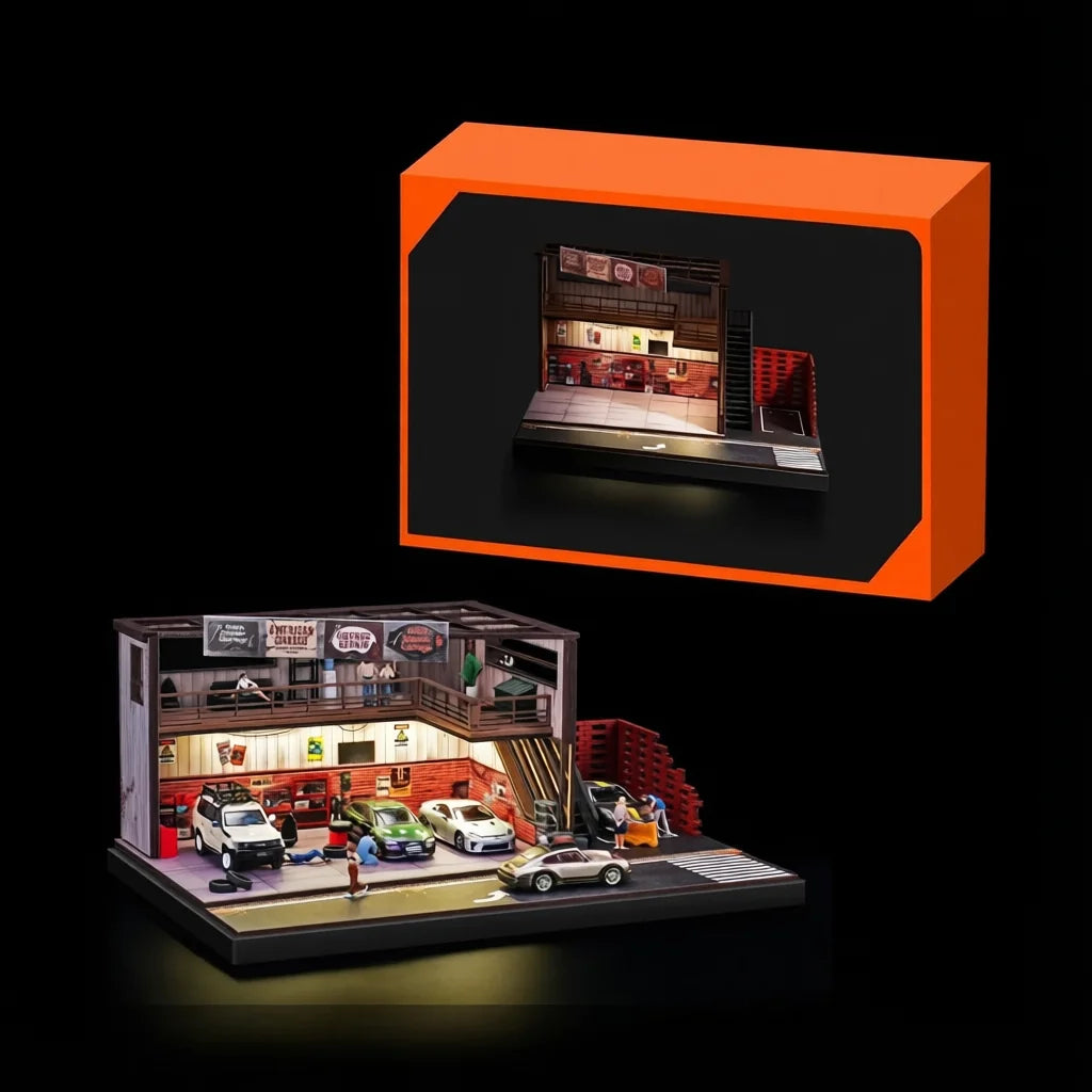 Orange retail box with a cut-out window beside the fully assembled garage diorama