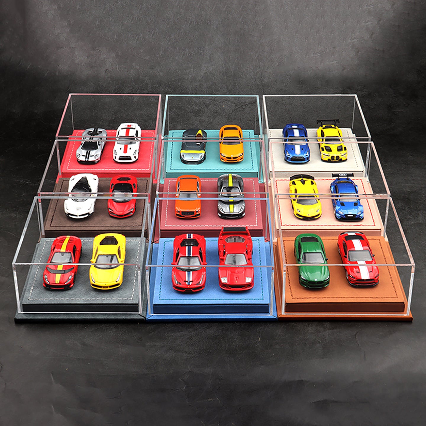 Collection of colorful model cars in a transparent display case on a dark background