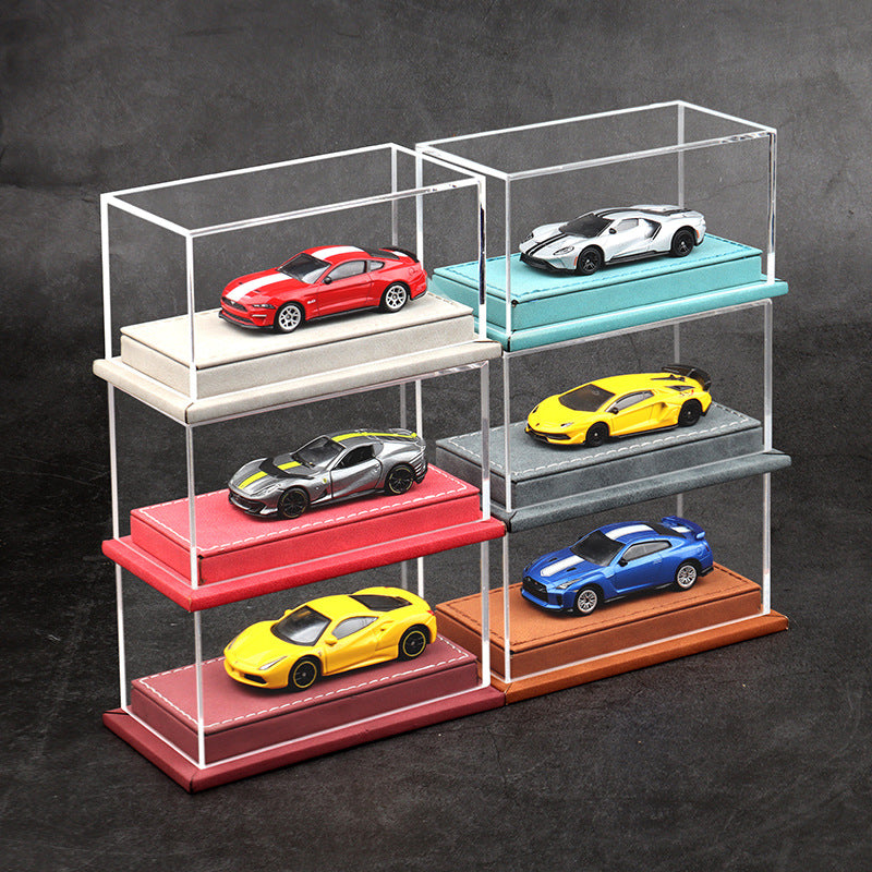 Clear acrylic display case with colorful model cars on a dark background