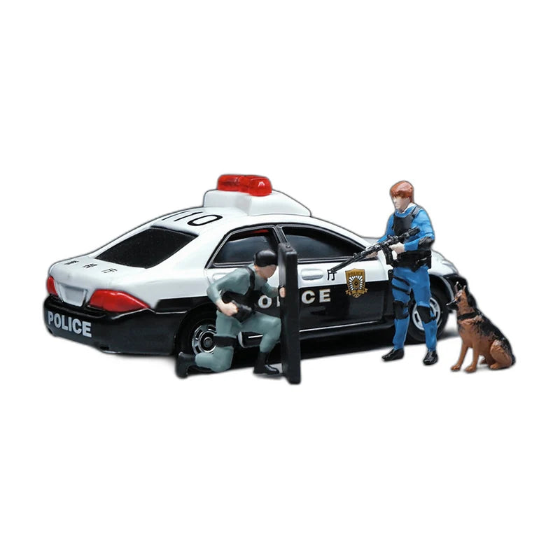 Two 1:64 police figures and a police dog posed beside a model patrol car